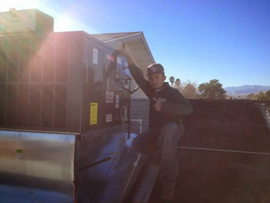 HVAC technician performing HVAC Inspection on a rooftop unit in Cedar Grove